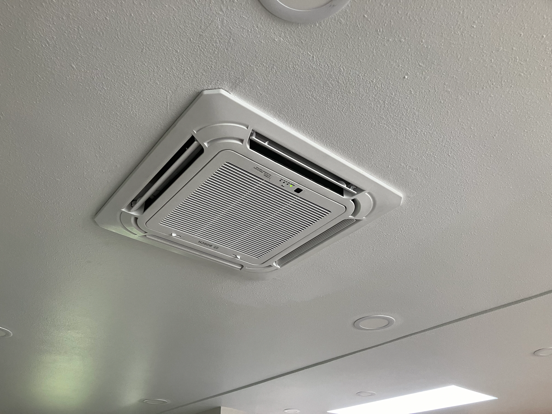 Ceiling cassette mini-split unit installed flush with ceiling