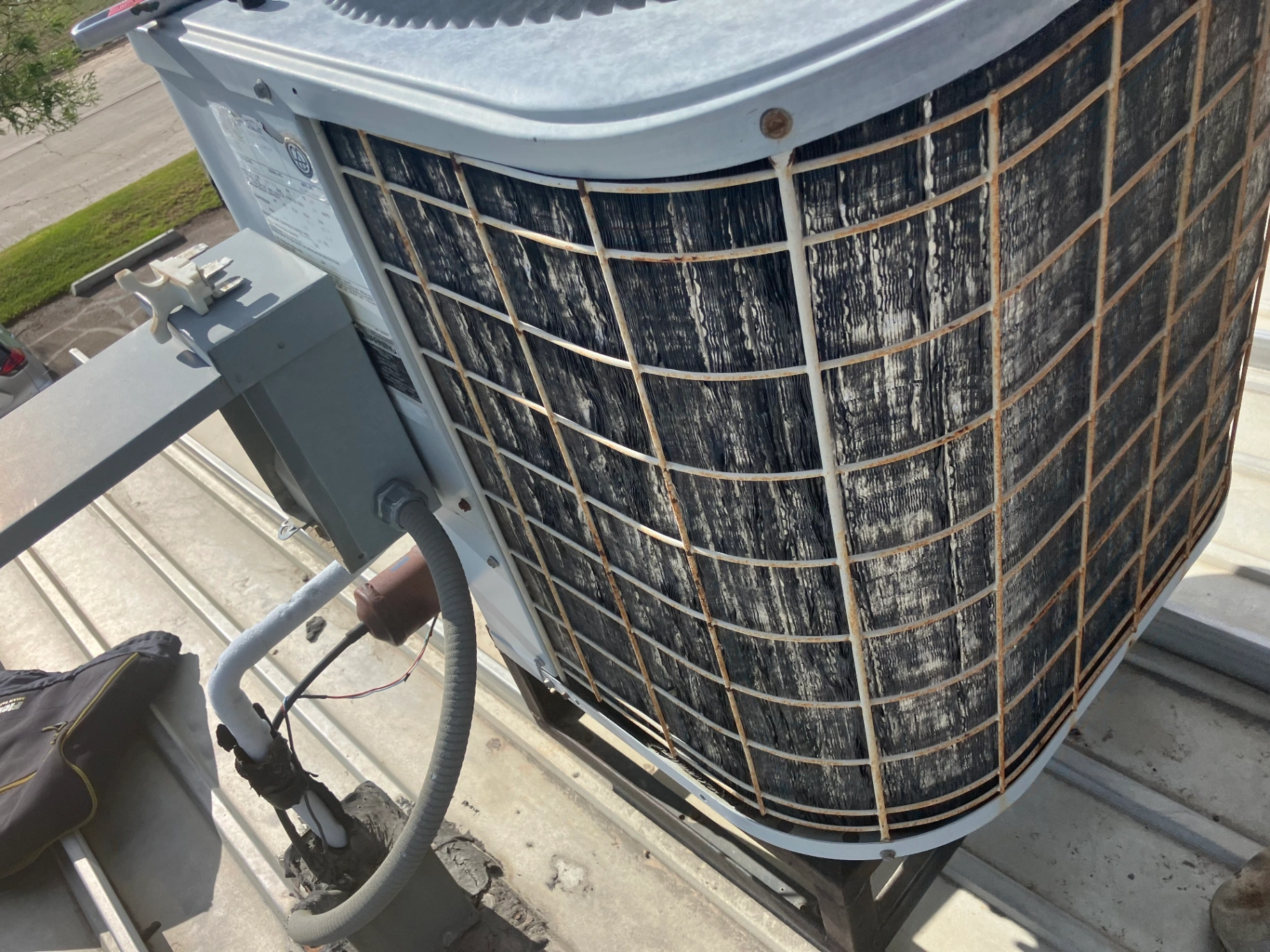 Dirty AC condenser unit needing professional cleaning and repair service