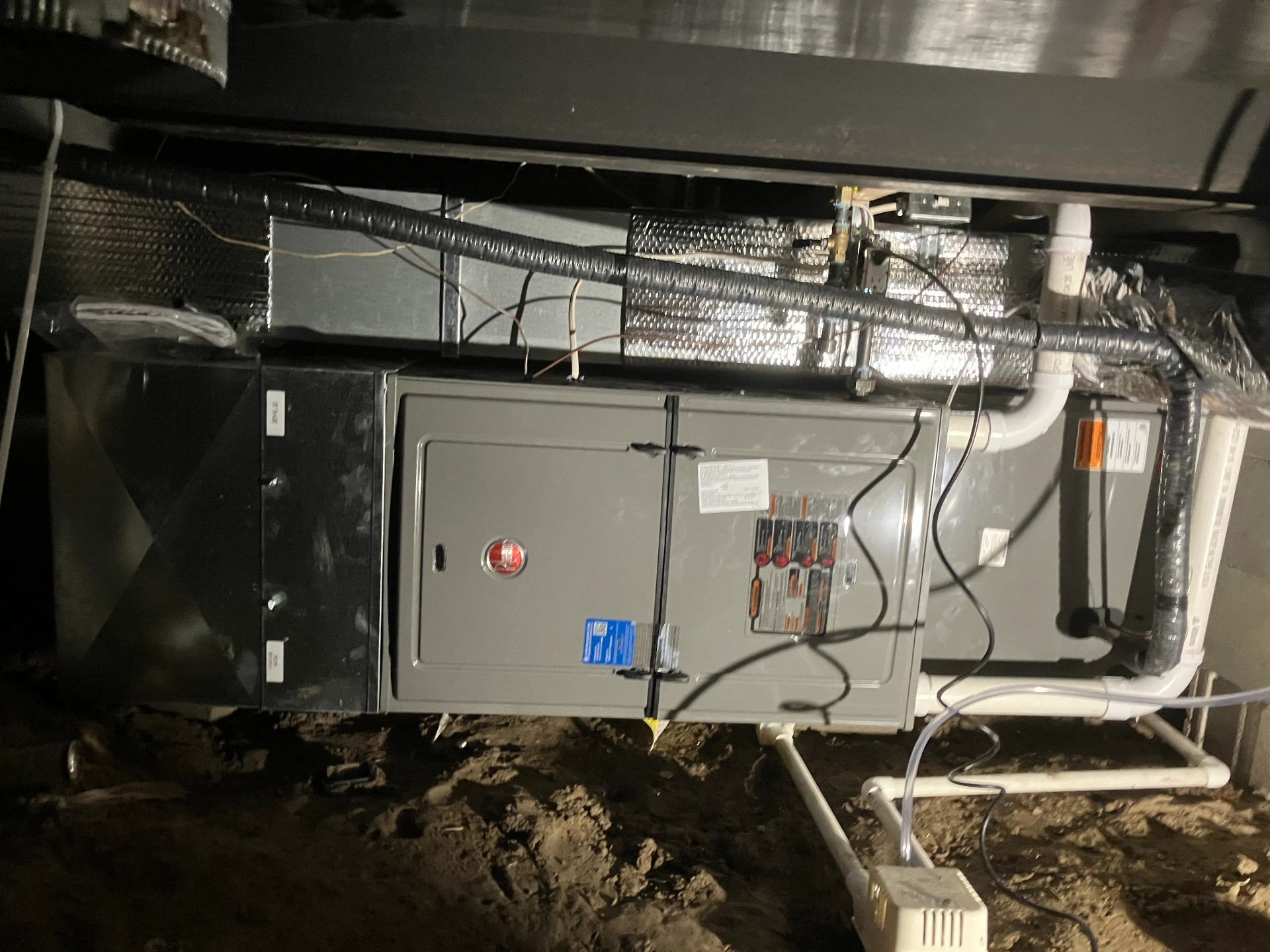 High-efficiency residential furnace installation showing professional setup and qualifying equipment for federal tax credits and utility rebates